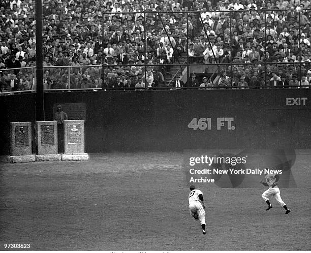 Game 1 of the 1949 World Series between the Brooklyn Dodgers and the New York Yankees at Yankee Stadium. Joe DiMaggio [right] gives chase to ball...