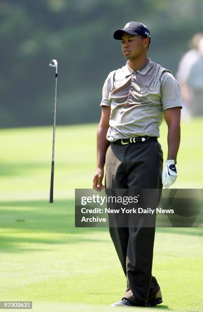 Tiger Woods tosses a club after a bad shot on the second hole during first round play in the 87th PGA Championship at Baltusrol Golf Club in...