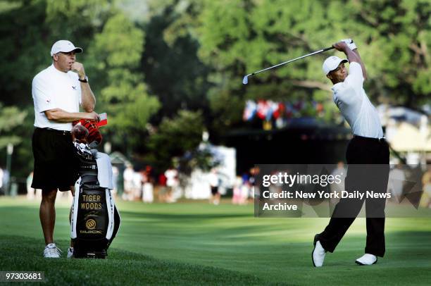 Tiger Woods watches his shot on the 17th fairway during his practice round at the 87th PGA Championship at Baltusrol Golf Club in Spingfield, N.J....