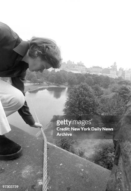 Tightrope walker Philippe Petit checks the tension of the cable atop Belvedere Castle Tower that he will walk on tonight in Central Park.