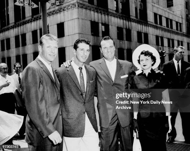 New York Yankees Mickey Mantle, Billy Martin, Hank Bauer and Bauer's wife Charlene leaving the district attorney's office after a grand jury declined...