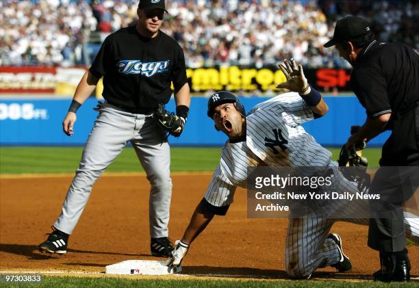 New York Yankees' Miguel Cairo protests as third base umpire Chris Guccione calls him out on a tag by Toronto Blue Jays' third baseman Eric Hinske...