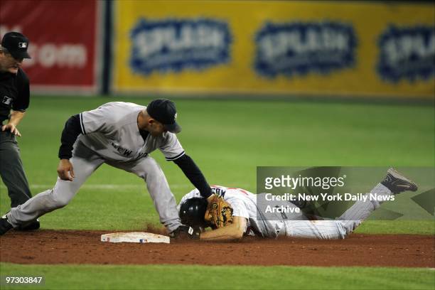 New York Yankees' Miguel Cairo puts the tag on Minnesota Twins' Corey Koskie, who was trying to stretch a hit into a double, during Game 3 of the...