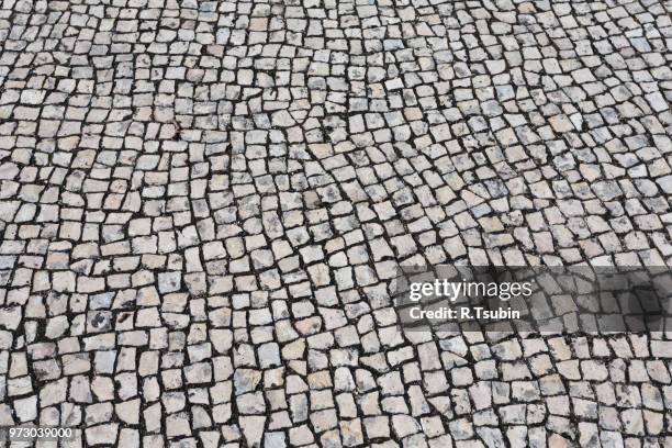background texture of typical portuguese walkway pavement - portugees straatmozaïek stockfoto's en -beelden