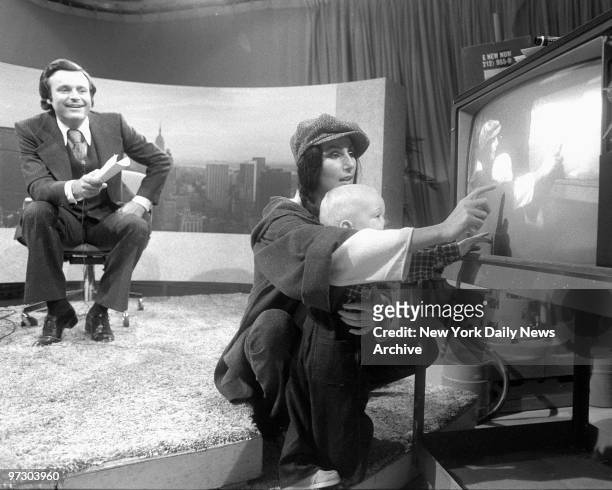 Cher, before taping of the Stanley Siegel TV show. Cher shows her son 14-month-old Elijah Blue a picture within a picture, See yourself on TV?