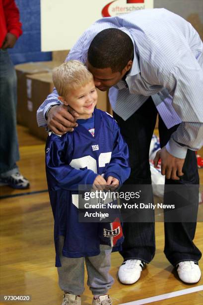 New York Giants' Michael Strahan shares a moment with Luke Falkenstern at the Norwood Elementary School in Norwood, N.J. The first-grader won the...