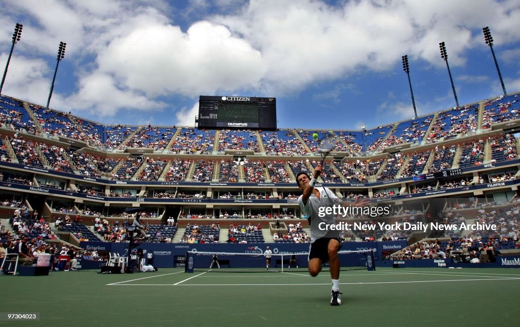 Tim Henman of Britain chases down a lob by Nicolas Kiefer of