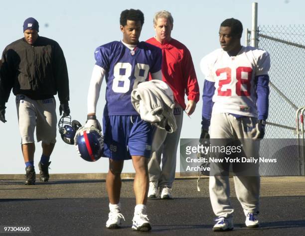 New York Giants' Michael Strahan, Ike Hilliard, coach John Fox and Reggie Stephens leave Giants Stadium after a practice session for their NFC...