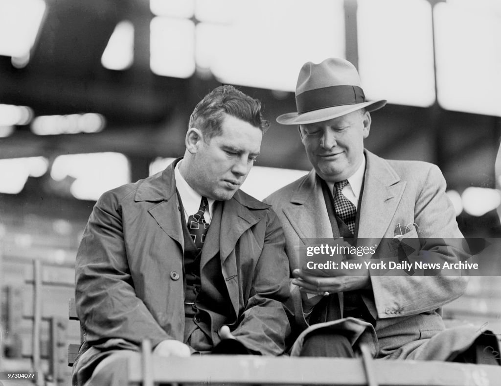 Tim Mara, owner of grid New York Giants, checks over race ca
