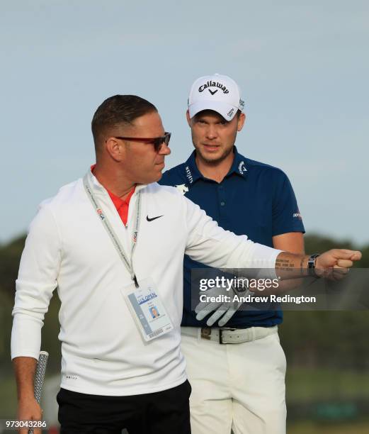 Danny Willett of England and swing coach, Sean Foley , are seen on the practice range during a practice round prior to the 2018 U.S. Open at...