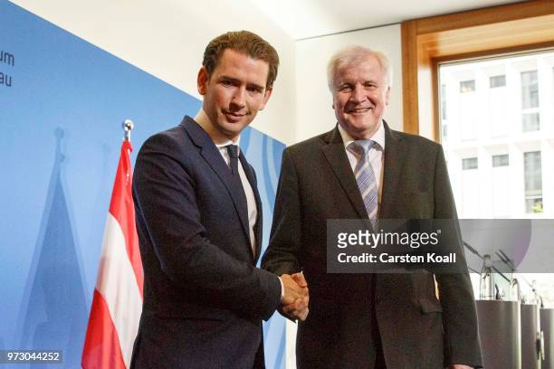 Austrian Chancellor Sebastian Kurz and German Interior Minister Horst Seehofer shake hands following a press conference on June 13, 2018 in Berlin,...