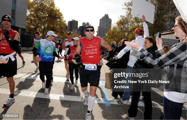 Matt Long, injured Fireman runs past the 18th mile mark on 99th St.and First Avenue at the New York City Marathon in Manhattan. Longs first race...