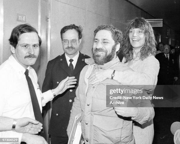 Johanna Lawrenson hugs Abbie Hoffman at Manhattan Supreme Court as he surrenders to Dept. Of Correction officer and court officer to begin three-year...