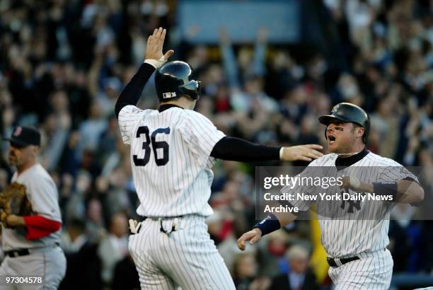 New York Yankees' Nick Johnson and Karim Garcia celebrate their runs in the fourth inning of Game 6 of the American League Championship Series...