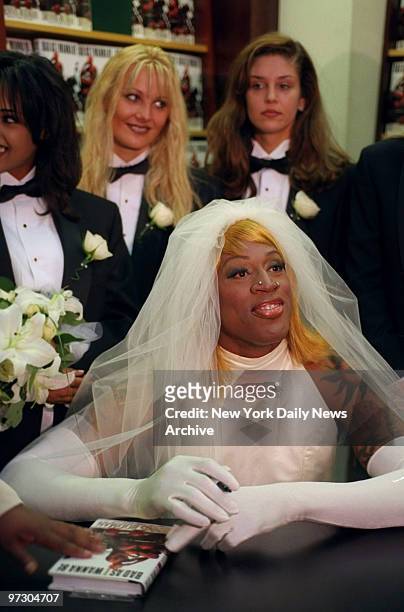 Chicago Bulls' basketball star Dennis Rodman, dressed in a wedding gown, signs copies of his new book "Bad As I Wanna Be" at Barnes and Noble on...