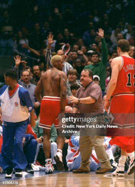 Chicago Bulls' Dennis Rodman disrobes after being ejected during game against New Jersey Nets. Rodman was ejected after head-butting referee Ted...