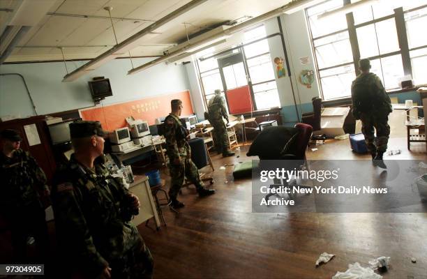 Soldiers from the Oregon National Guard walk through a public school in the 9th Ward neighborhood of New Orleans looking for survivors and bodies in...