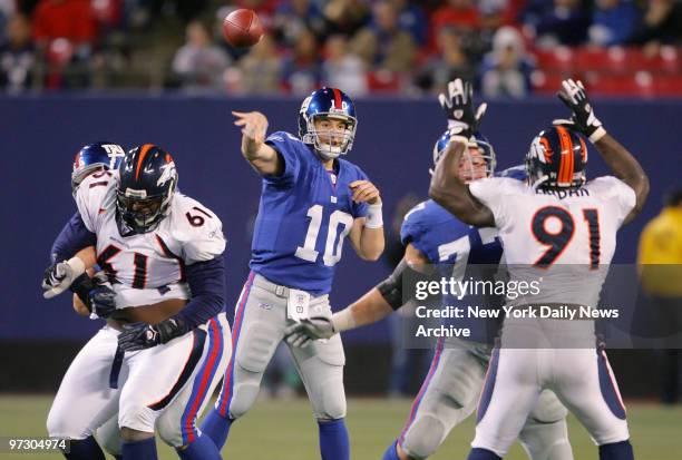 New York Giants' quarterback Eli Manning passes the ball in the fourth quarter against the Denver Broncos at Giants Stadium. Manning threw for 214...