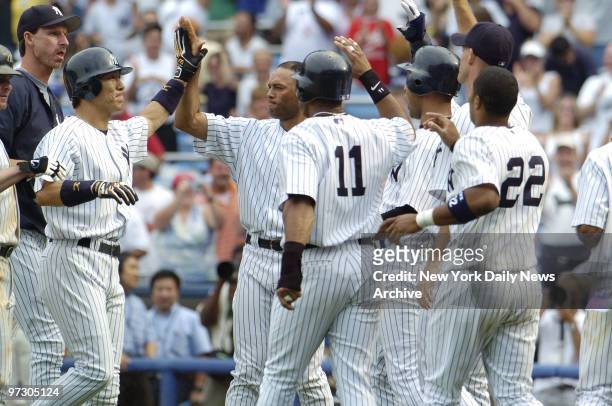 New York Yankees' outfielder Hideki Matsui is mobbed by teammates, including Randy Johnson , Mariano Rivera , Gary Sheffield and Robinson Cano ,...
