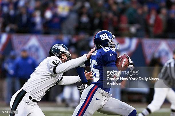 New York Giants' wide receiver Ron Dixon slips the grasp of Philadelphia Eagles' David Akers as Dixon heads for a TD on return of Akers' kickoff at...