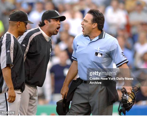 Chicago White Sox's umpire Ozzie Guillen and home plate umpire Phil Cuzzi have a shouting match after Guillen was ejected for arguing balls and...