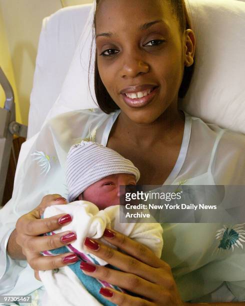 Maurica Robinson cuddles her newborn son, Peter Ashfield 3rd, at SUNY Downstate Hospital in Brooklyn. Peter is New York City's first newborn of 2001,...