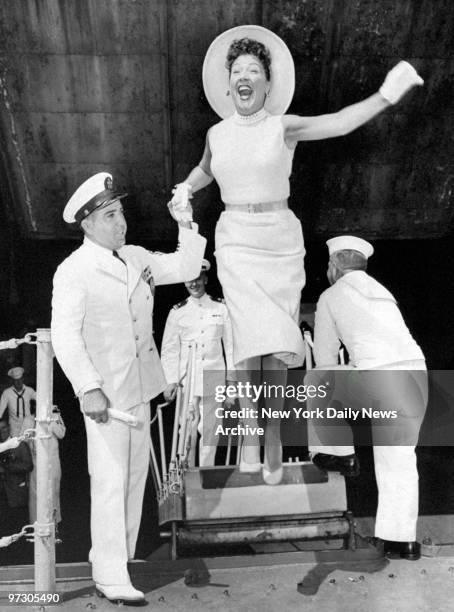 Chief Boatswain's Mate Joseph Sciara helps Ethel Merman aboard the Mitscher, where she read Mayor Wagner's proclamation designating Aug. 2 through 5...