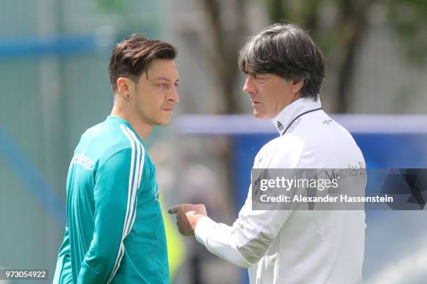 Joachim Loew, head coach of Germany talks to his palyer Mesut Oezil during the Germany training session ahead of the 2018 FIFA World Cup at CSKA...