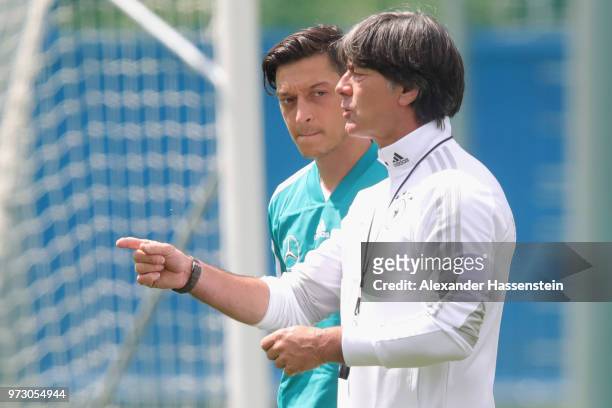 Joachim Loew, head coach of Germany talks to his palyer Mesut Oezil during the Germany training session ahead of the 2018 FIFA World Cup at CSKA...