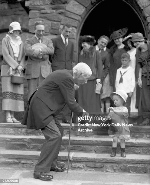 John D. Rockefeller marks his 84th birthday by handing out a nickel to Robert Irving Hunter who politely gives it back at first, after services at...