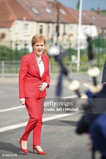 First Minister Nicola Sturgeon smiles at a bagpiper as she opens the new Largs Campus school building on June 13, 2018 in Largs,Scotland. The new...