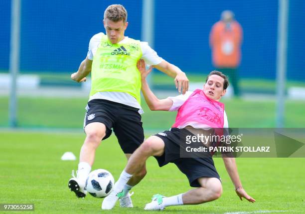 Germany's defender Matthias Ginter and forward Sebastian Rudy vie for the ball during a training session in Vatutinki, near Moscow, on June 13 ahead...