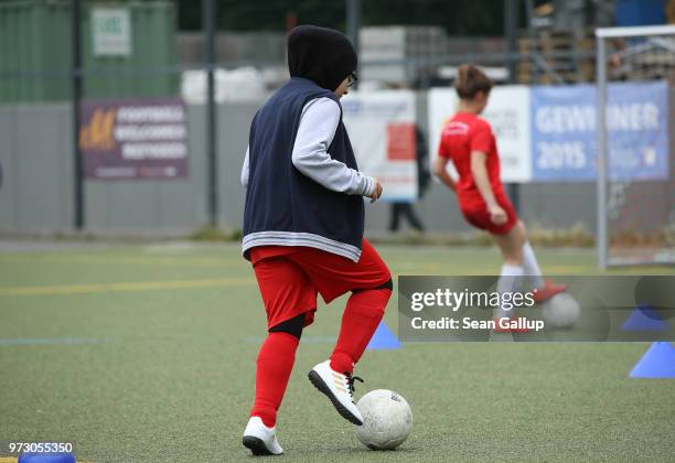 Young Muslim girl wearing a headscarf participates in a training day in a program to encourage integration of children with foreign roots through...