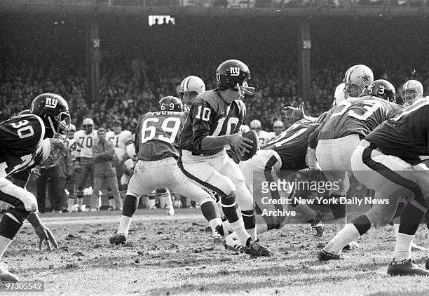 New York Giants' quarterback Fran Tankerton sets up behind the protection of Willie Young Charlie Harper and Greg Larson for pass at Yankee Stadium.