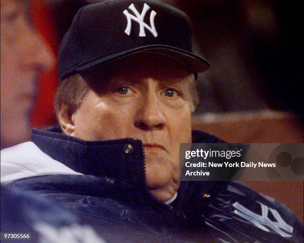 New York Yankees' owner George Steinbrenner is bundled up against the chill winds as he watches Game 5 of the American League Championship Series...