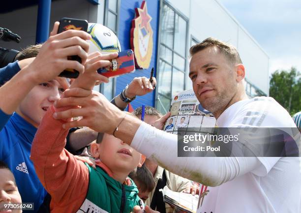 Manuel Neuer of Germany takes a selfie with fans during the Germany training session ahead of the 2018 FIFA World Cup at CSKA Sports Base on June 13,...