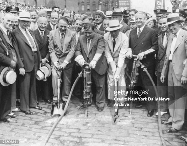 Gen. Hugh Johnson, Mayor Fiorello LaGuardia, Parks Commissioner Robert Moses and Samuel Levy wield tools in ground breaking ceremony for the new East...