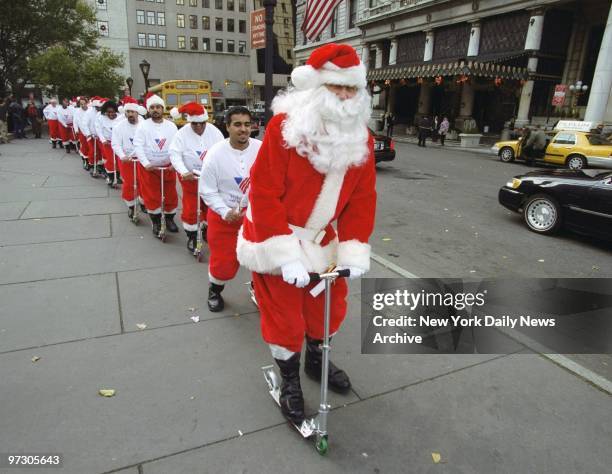 Chief Santa Claus Cliff Schneider leads a troop of potential Volunteers of America sidewalk Santas as they scoot through a training session at the...