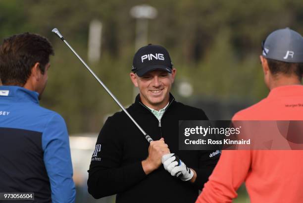 Matt Wallace of England talks with coach Robert Rock and Justin Rose of England on the driving range during a practice round prior to the 2018 U.S....