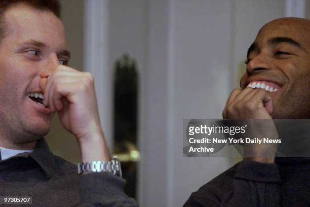 New York Giants' quarterback Kerry Collins and running backTiki Barber goof around while waiting to speak at a news conference about the NFC...