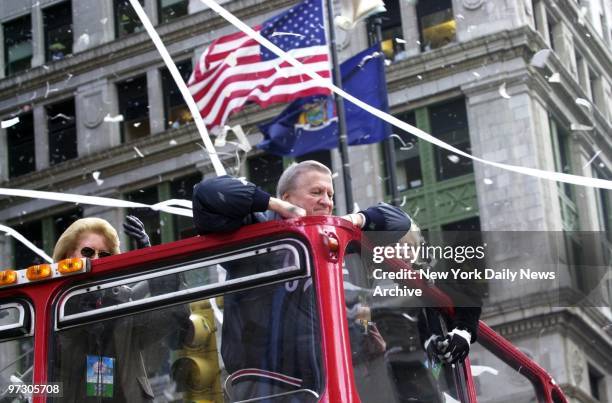 New York Yankees' owner George Steinbrenner takes it all in from the top of a double decker bus as floats carrying the World Champion New York...