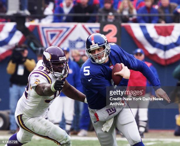 New York Giants' quarterback Kerry Collins eludes the grasp of Minnesota Vikings' Fernando Smith in the NFC Championship Game at Giants Stadium....