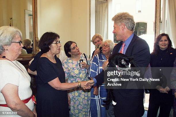 Socks, the ex-First Cat, goes along for the ride as former President Bill Clinton says goodbye to staff members and volunteers at his Washington...