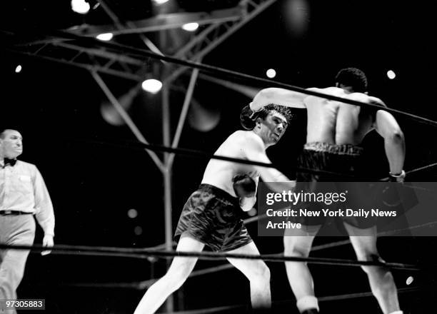 Max Schmeling versus Joe Louis I at Yankee Stadium., Mighty Louis totters on rubbery legs in fourth round as Schmeling smashed home a right, the...