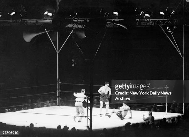 Max Schmeling versus Joe Louis I at Yankee Stadium., Now, Max closes in on his foe in the first round, crouching, looking for an opening to shoot...