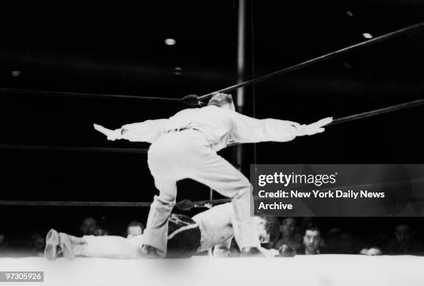 Max Schmeling versus Joe Louis I, Louis lies face downward on the canvas in the 12th round, knocked senseless by Schmeling's right to the jaw. The...