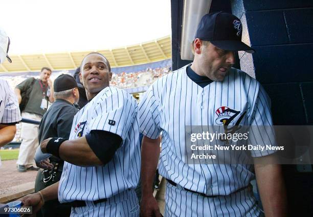 New York Yankees' picture Roger Clemens walks past Kevin Thompson as he head to the clubhouse after tossing six scoreless innings for the Scranton...