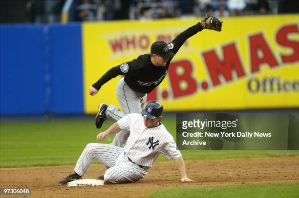 New York Yankees' pinch runner Aaron Guiel is out at second but breaks up a double play by Toronto Blue Jays' shortstop Aaron Hill to leave Bernie...