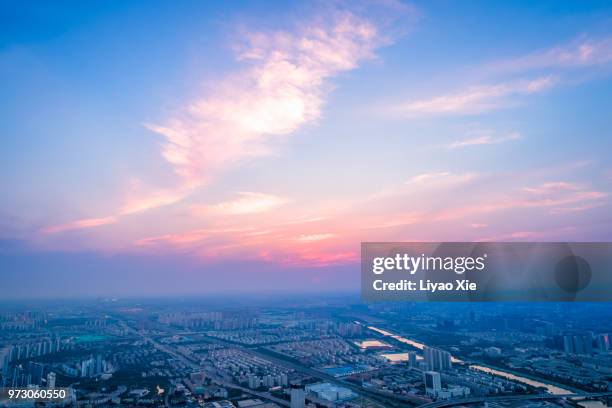 dramatic sky and cityscape - xie liyao stock pictures, royalty-free photos & images