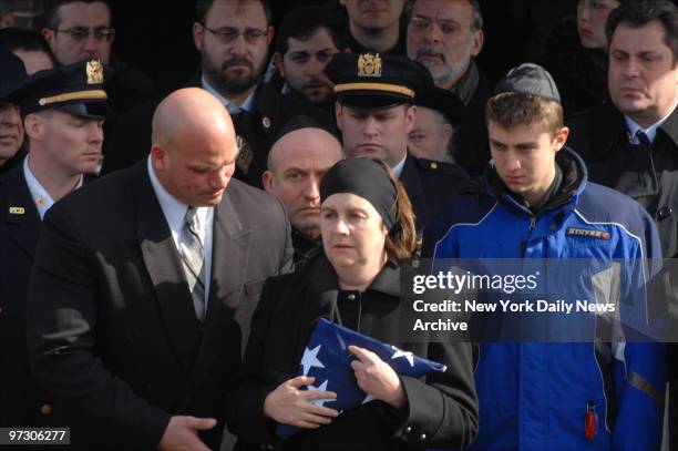 Maya Marshalik holds the folded flag that was draped over her slain son Eugene's coffin, outside the I.J. Morris Funeral Home in Midwood, Brooklyn....